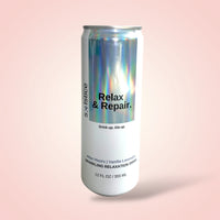Silver can with 'Relax & Repair' text on a pink background - A skin care drink made for relaxation. Giving you the most restful sleep.